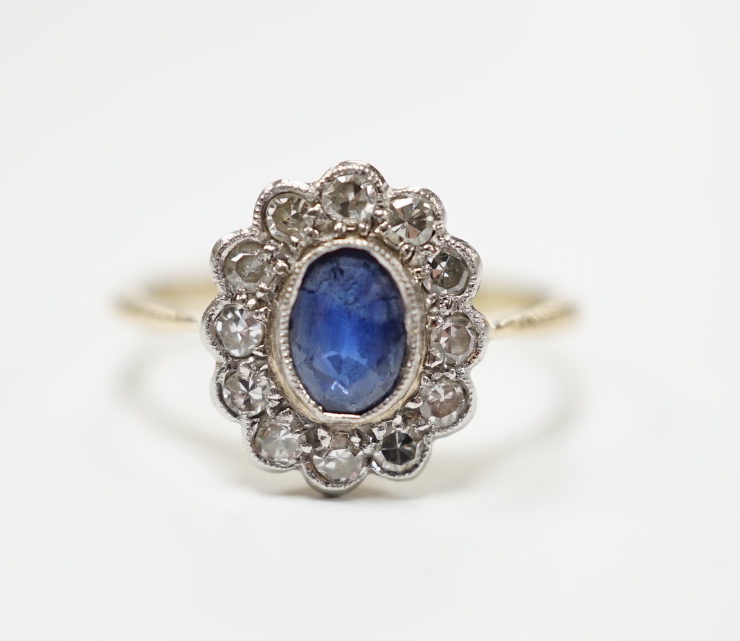 An early to mid 20th century 18ct and plat. sapphire and diamond set oval cluster ring, size L, gross weight 2.5 grams.